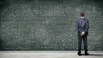 Business person standing against the blackboard with a lot of data written on it